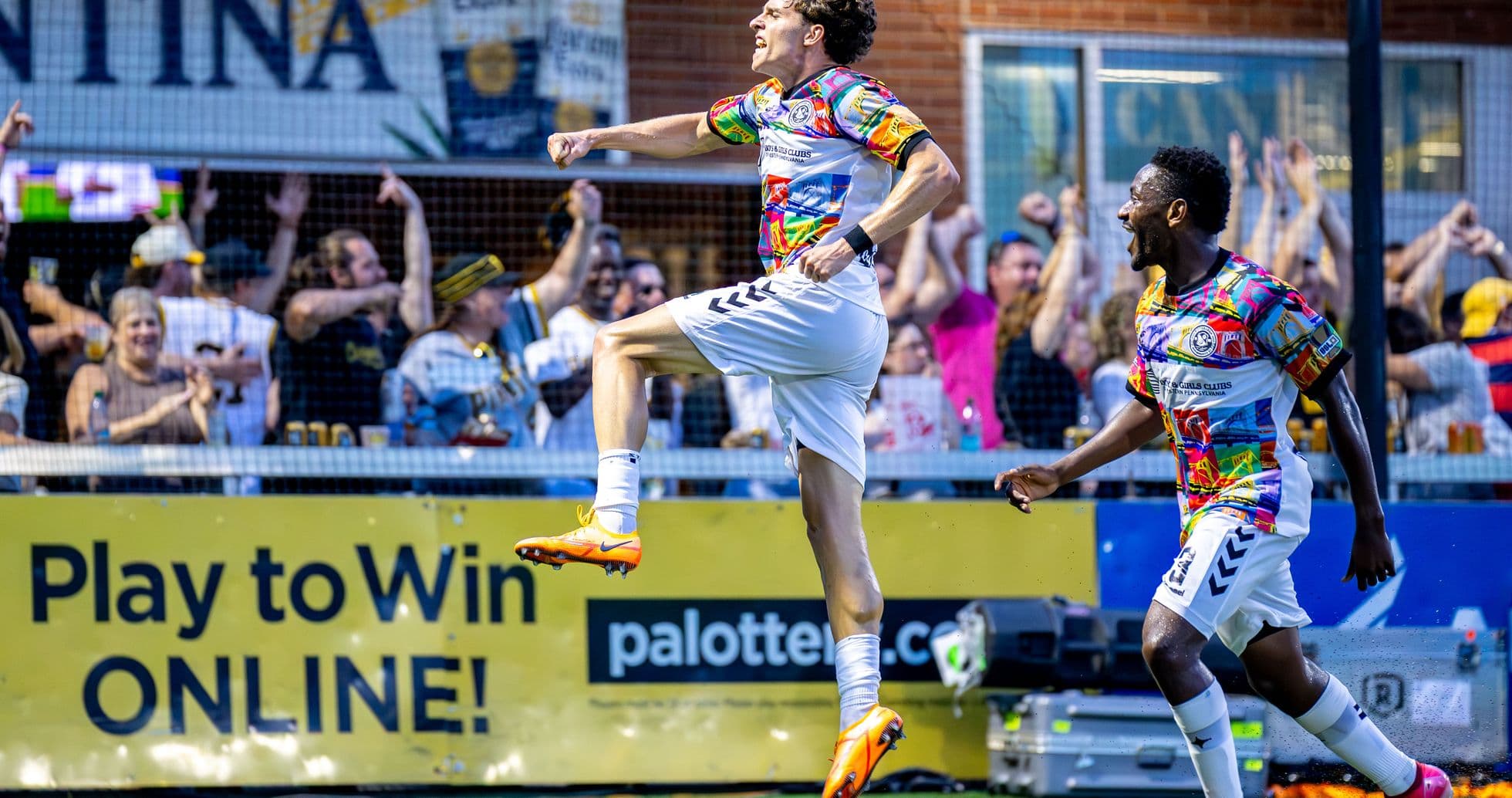 Player celebrating goal with fans in background