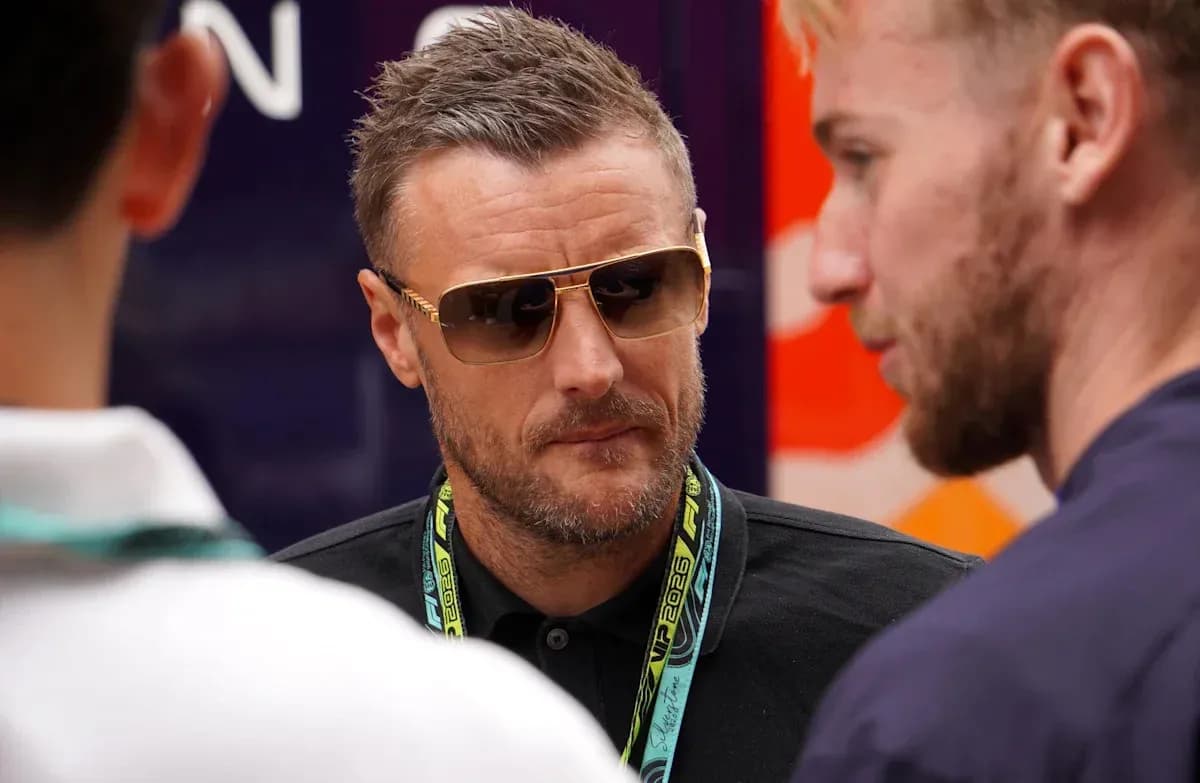 Man in sunglasses talking with two others