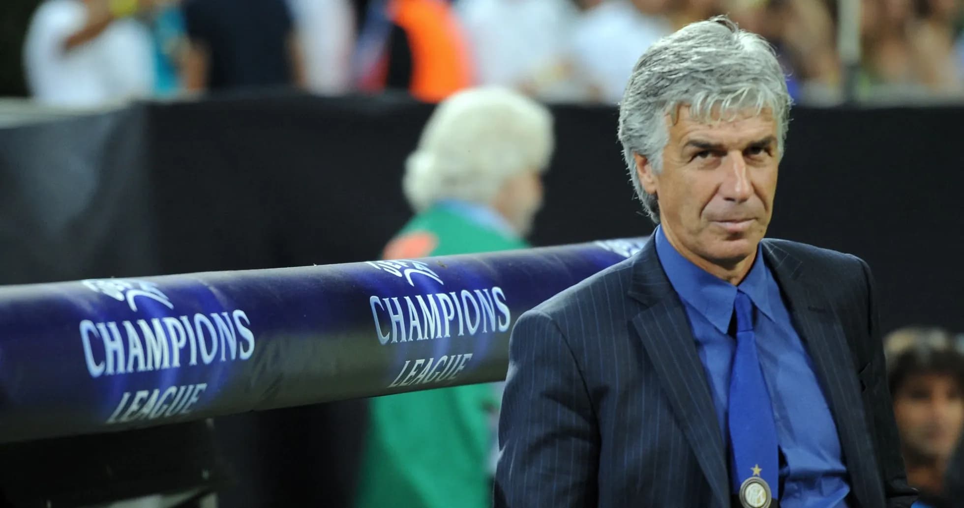 Coach sitting on bench during Champions League match