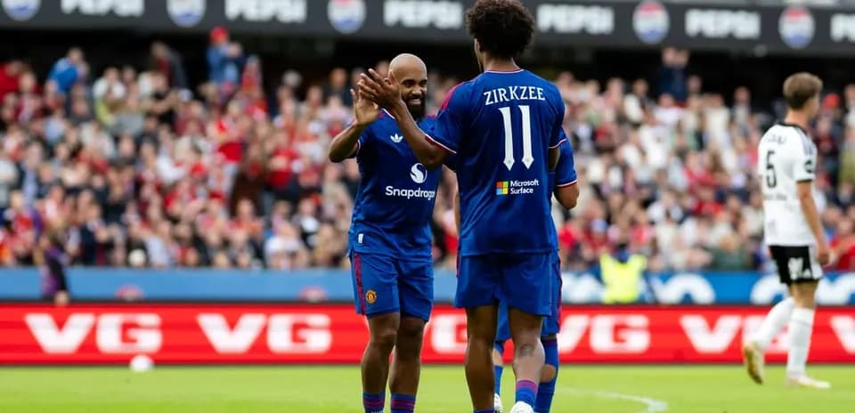 Players celebrating during match with fans in background