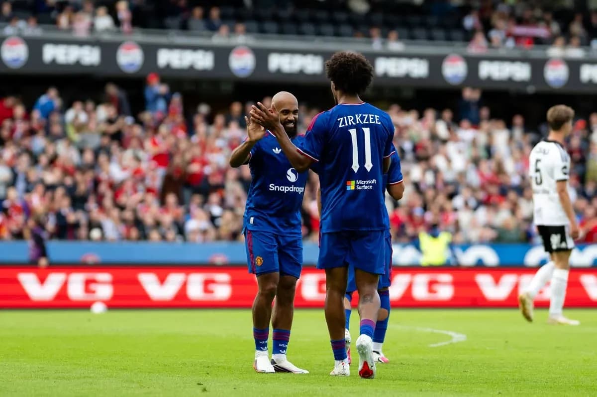 Players celebrating during match with fans in background