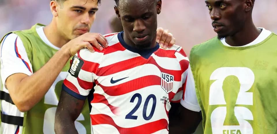 USA players supporting teammate during World Cup match