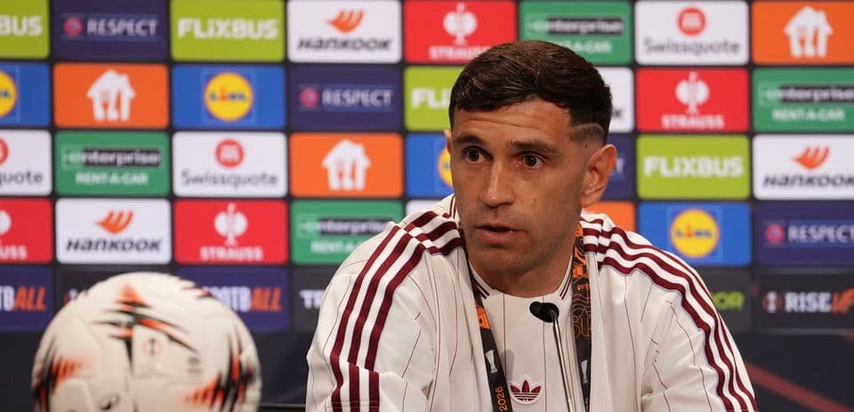 Player speaking at press conference with ball