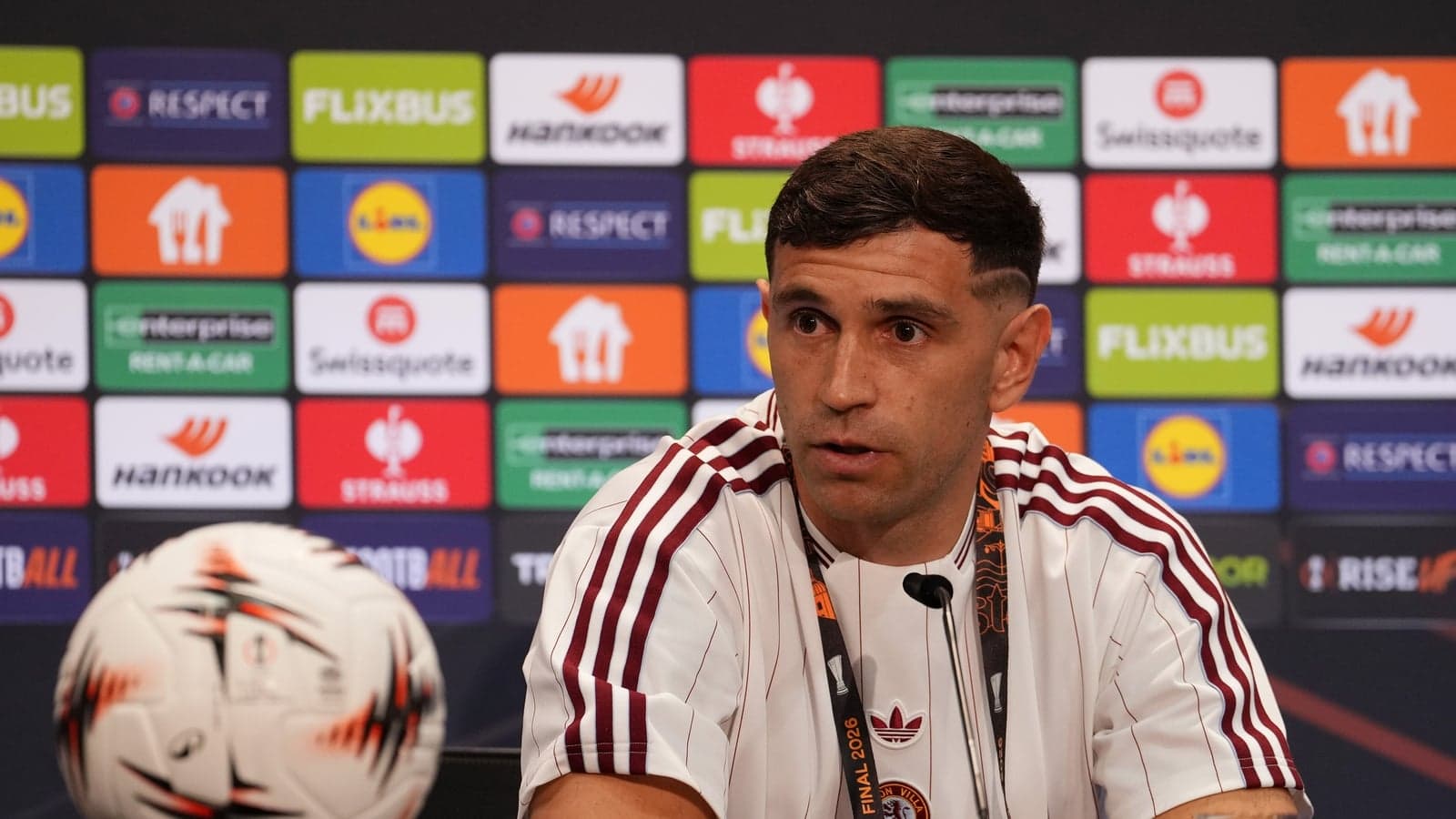 Player speaking at press conference with ball