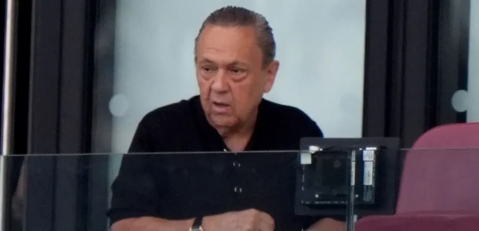 Man in a black shirt at a sports venue