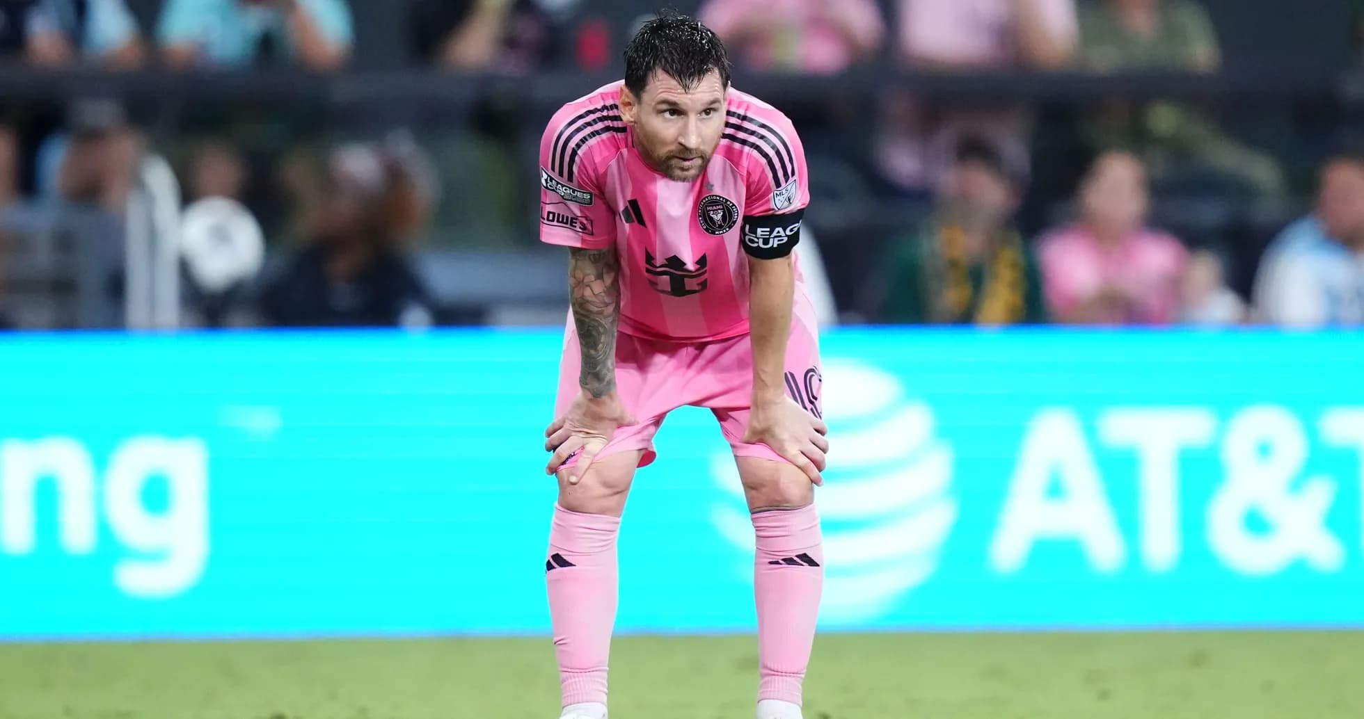 Player in pink jersey resting during match