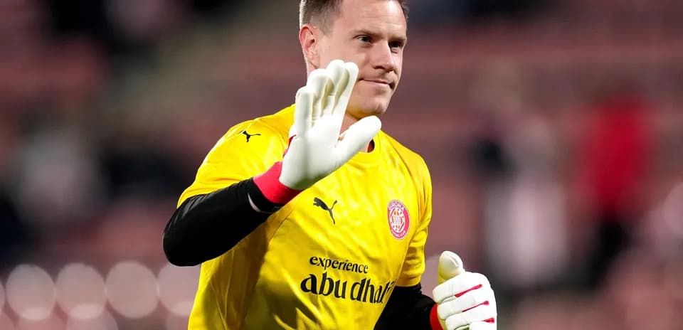 Goalkeeper waving in yellow jersey and gloves