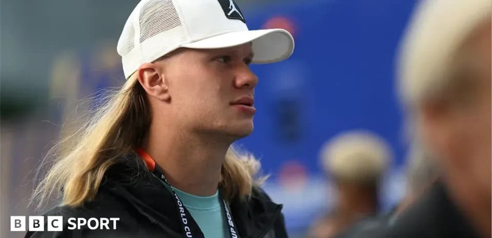 Man with long hair wearing a cap at event