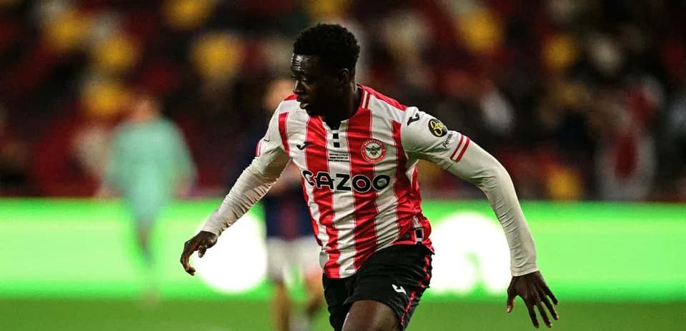 Player in red and white jersey running on pitch