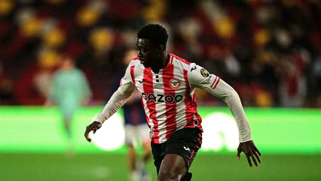 Player in red and white jersey running on pitch