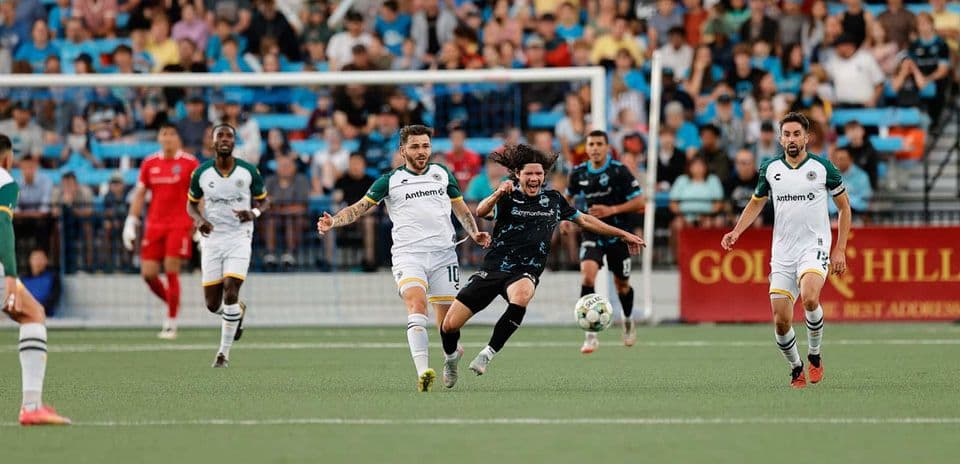 Players competing for the ball in USL match