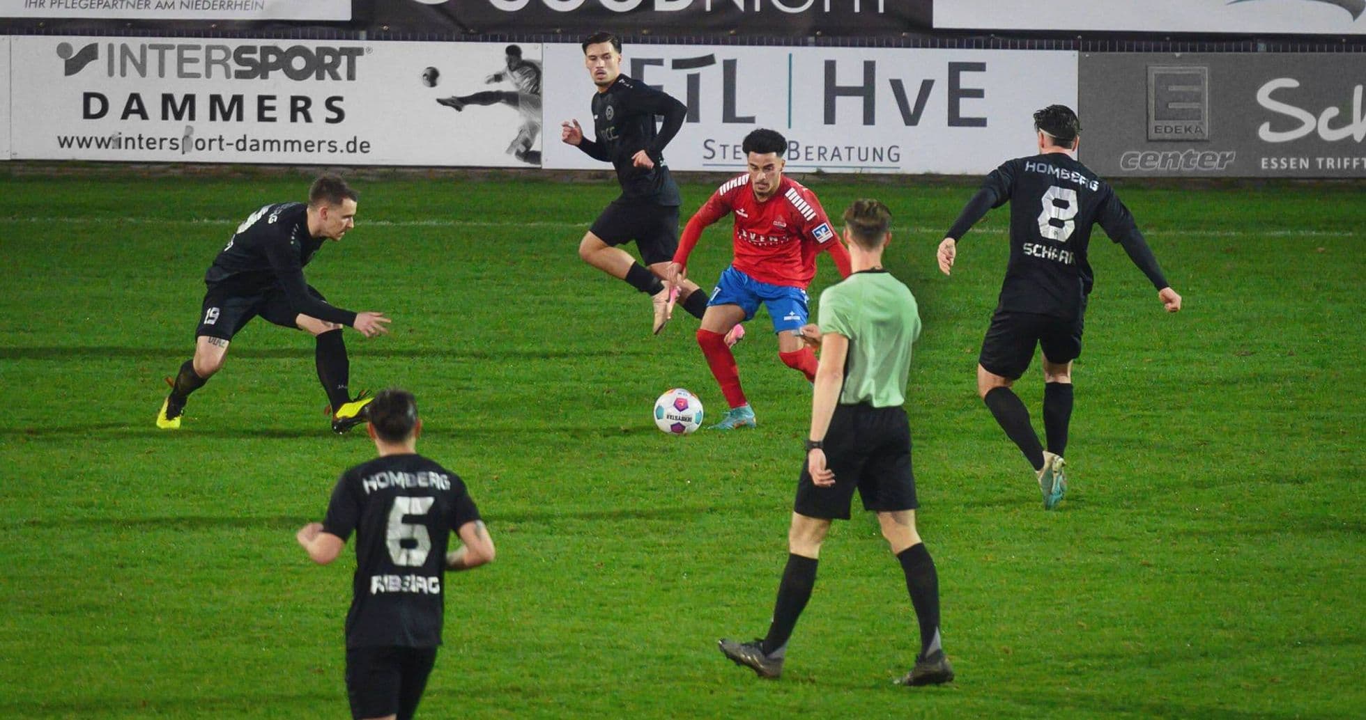 Players competing for the ball during match