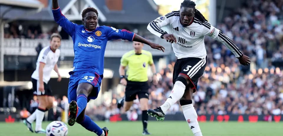 Fulham player tackling Manchester United opponent