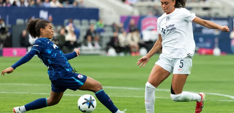 Two players competing for the ball during match