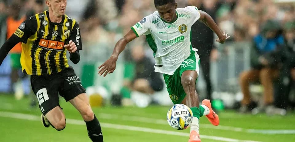 Player in white dribbling past opponent in black