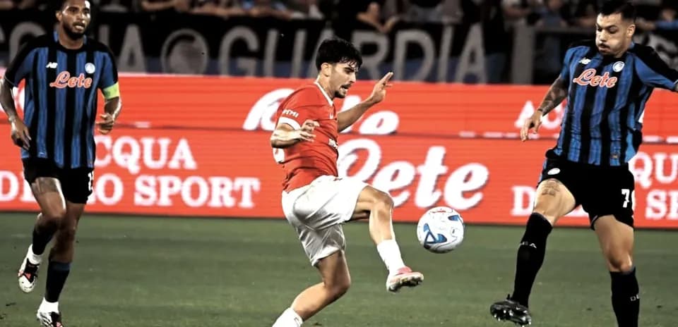 Player kicking ball during match between teams