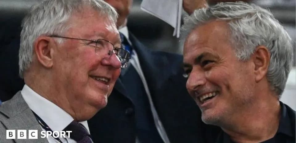 Two men smiling and chatting in the stands