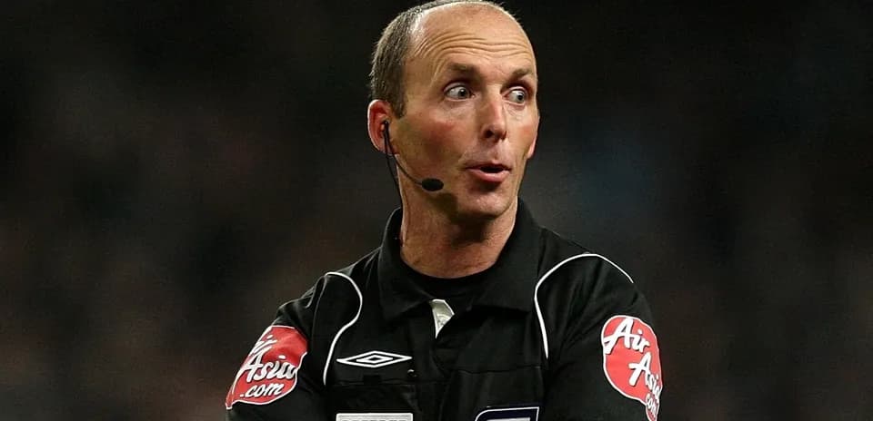 Referee officiating a match with a microphone