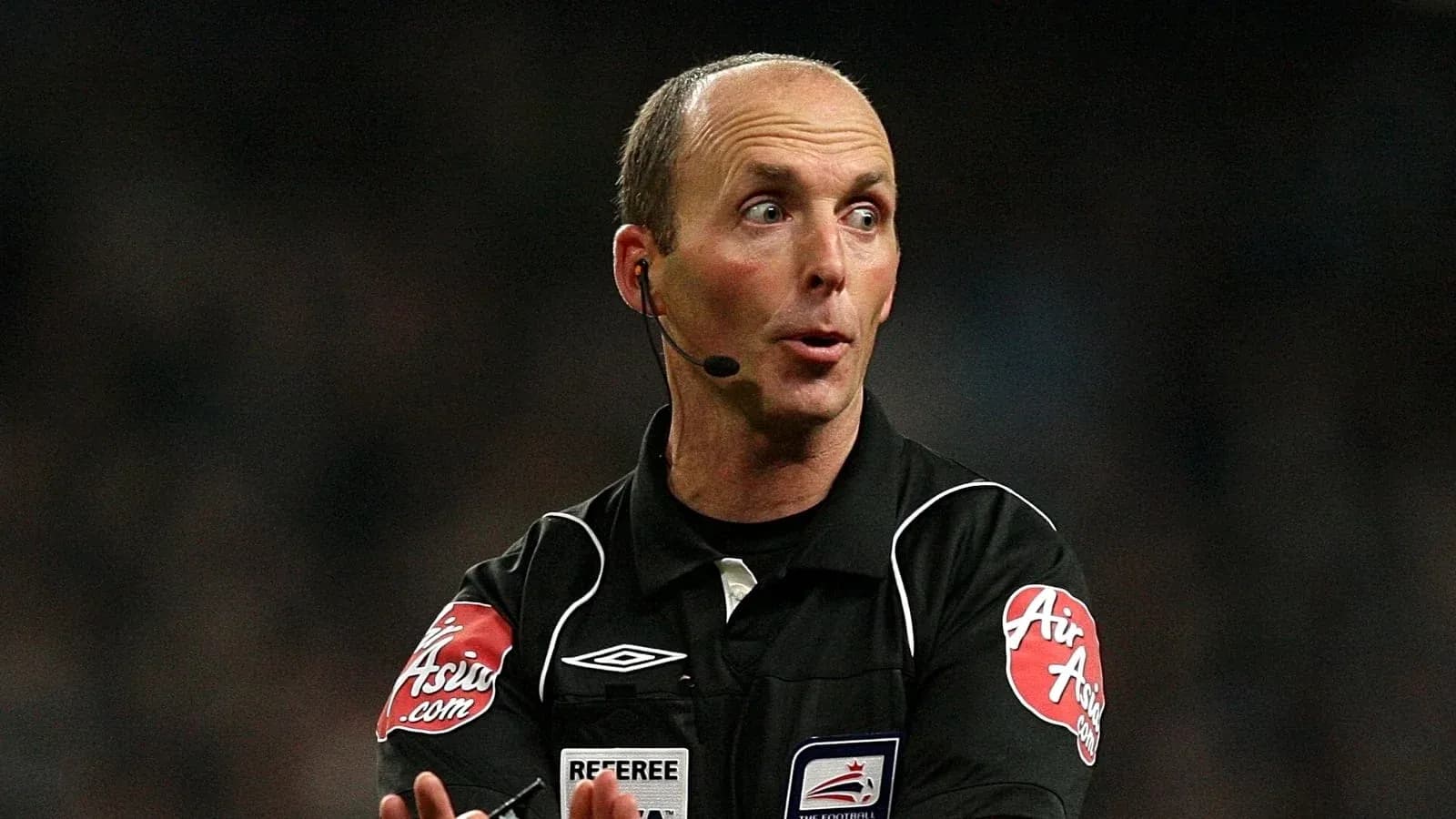 Referee officiating a match with a microphone