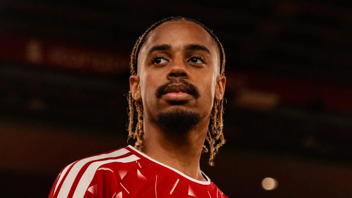 Player in red jersey looking into the distance