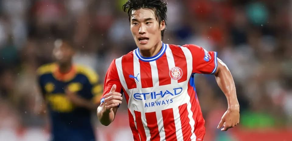 Player running with ball during football match