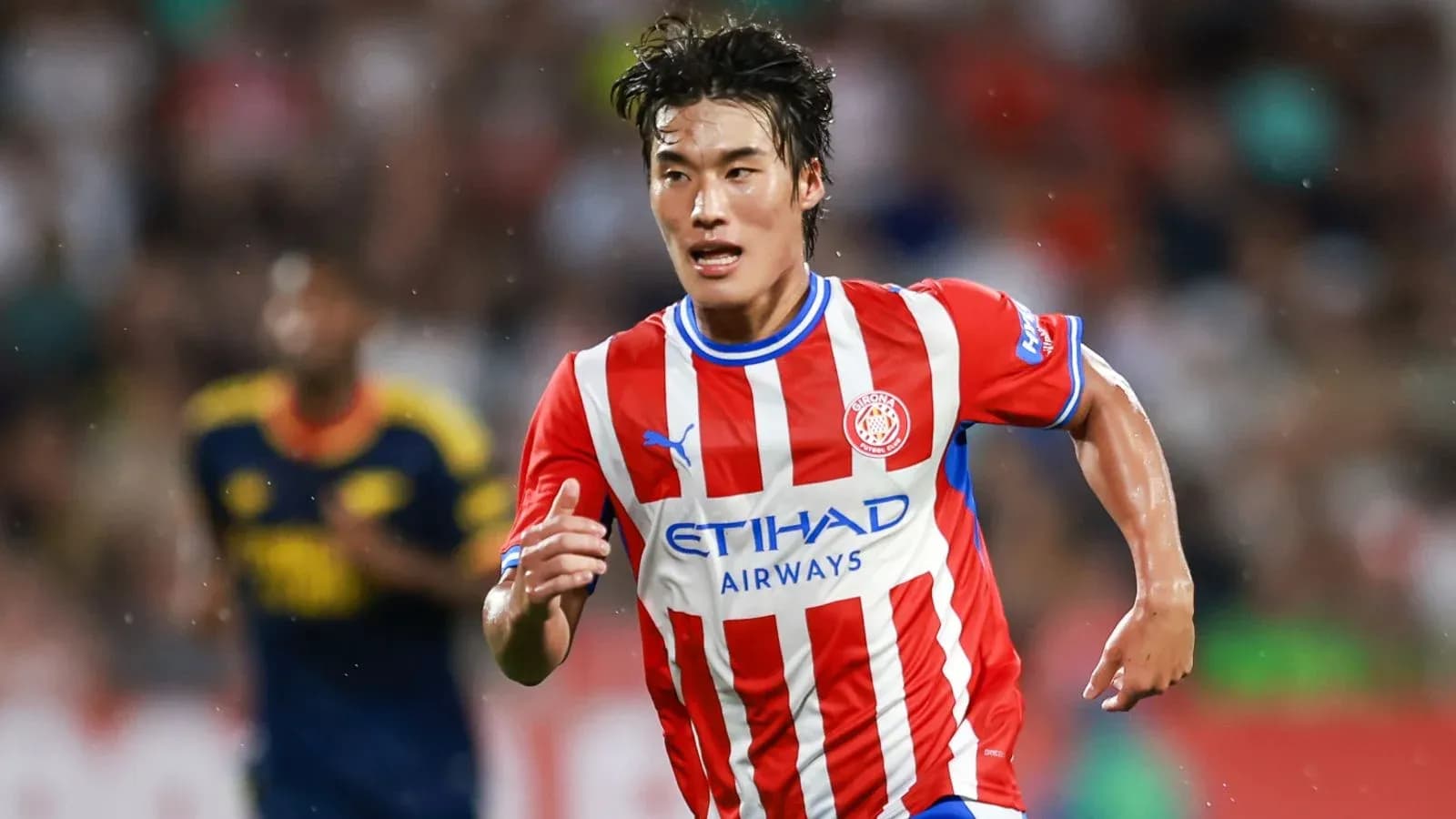 Player running with ball during football match