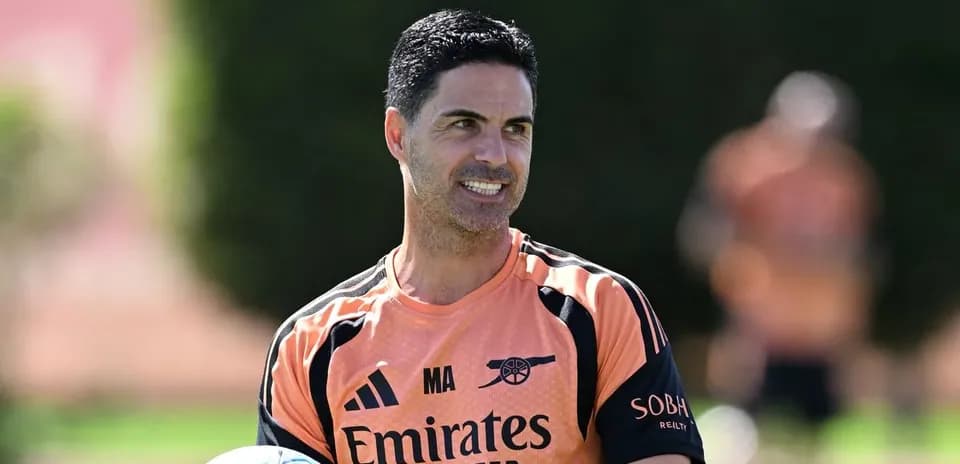 Coach holding a soccer ball during training session