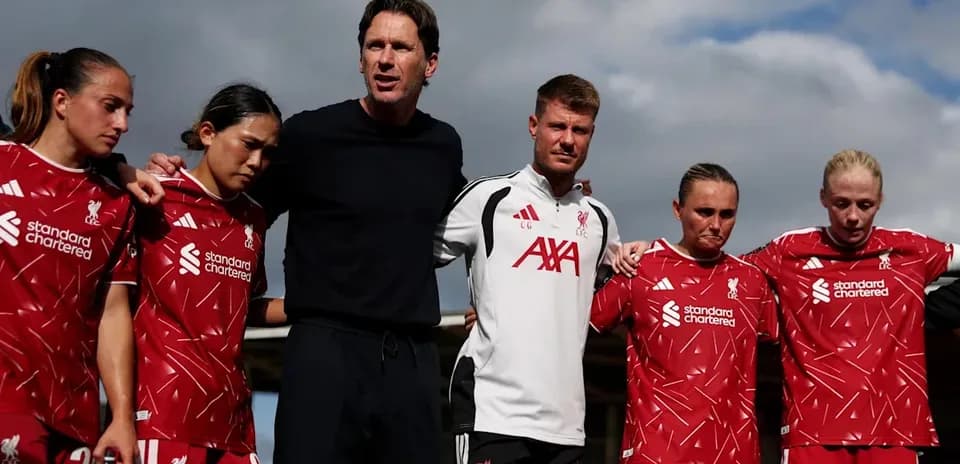 Liverpool women's team in huddle with coaching staff