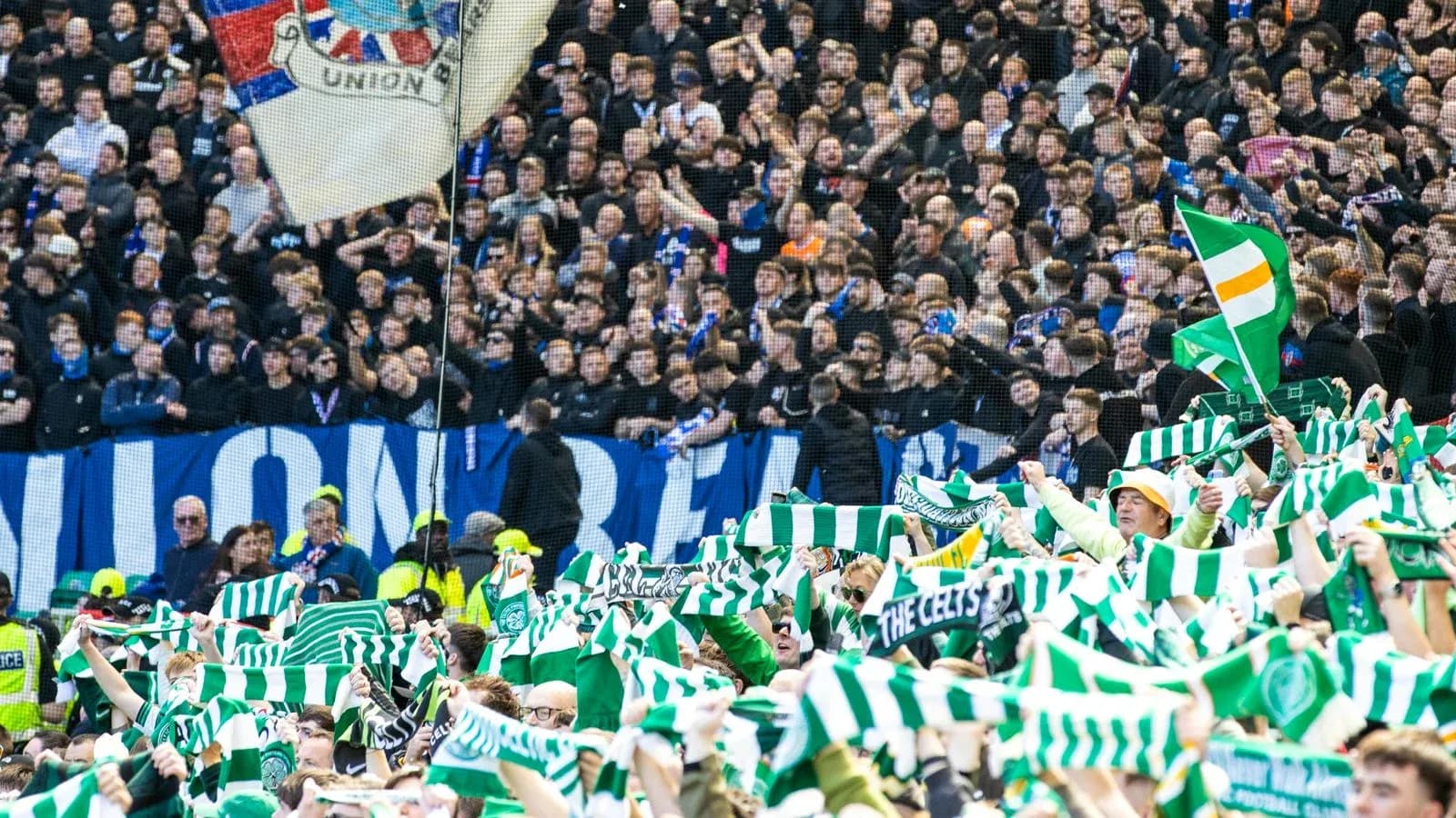 Celtic fans waving scarves in stadium stands