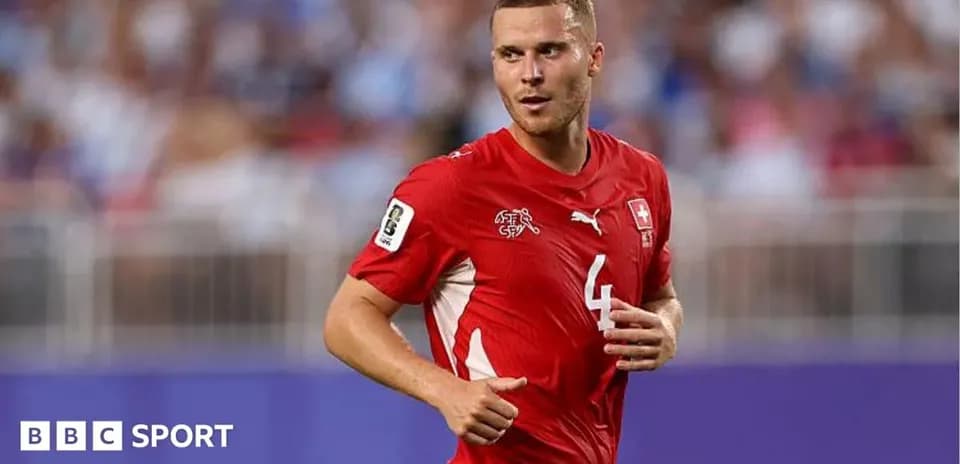 Swiss player running during a football match