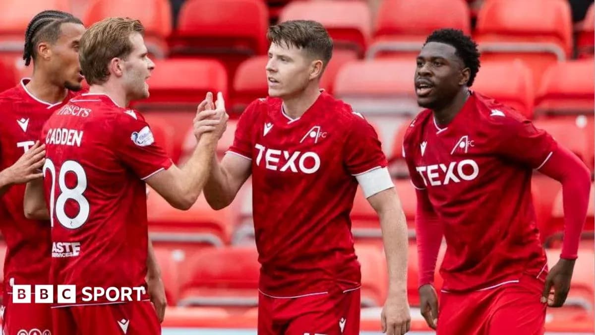 Players celebrating a goal on the pitch