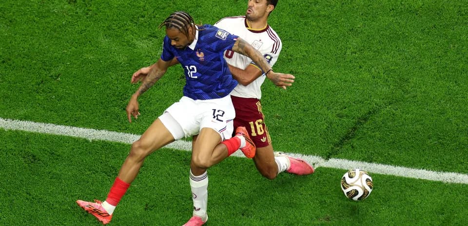 Two players contesting for the ball during match