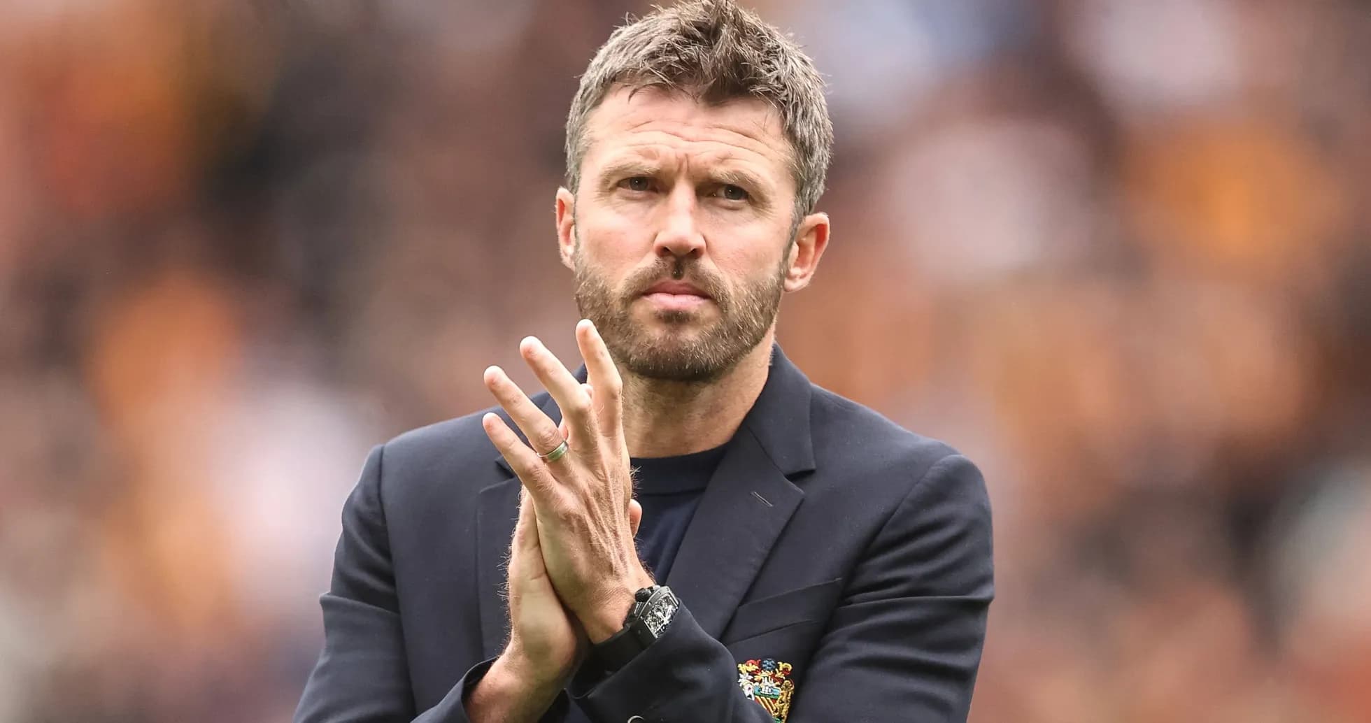 Coach clapping during a match on the sidelines