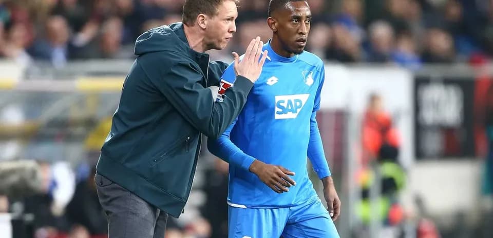 Coach giving instructions to player on the sidelines