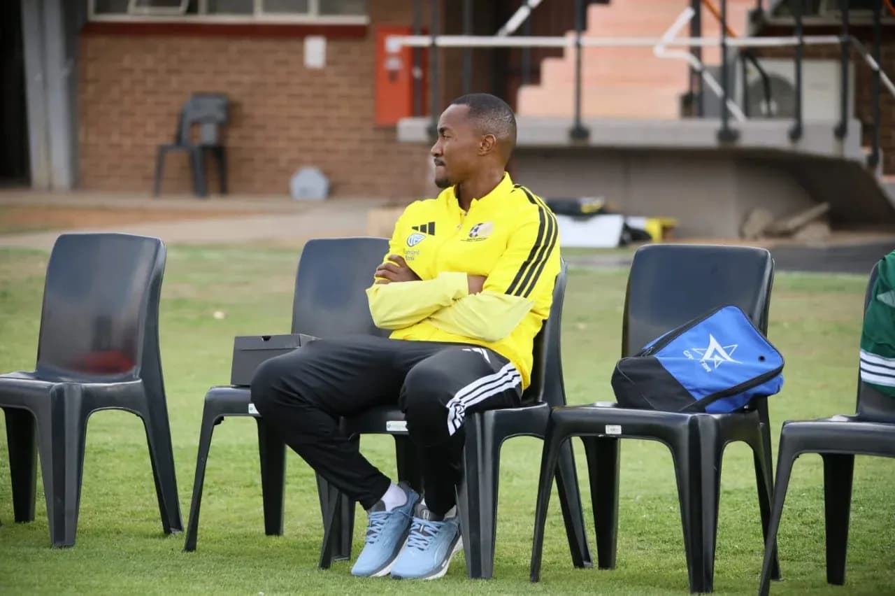 Coach sitting on bench during training session