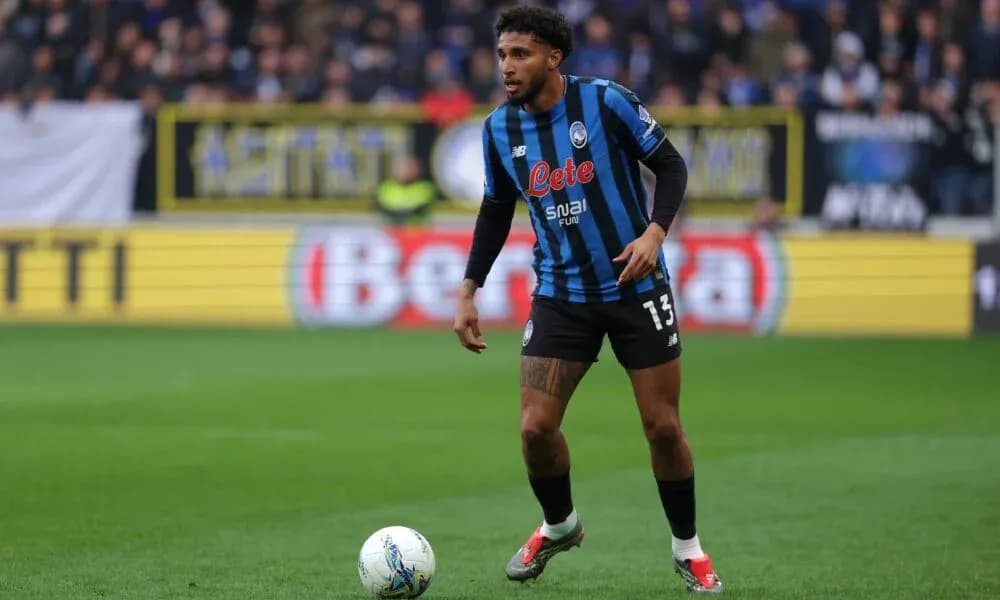 Player in Atalanta kit controlling ball on field