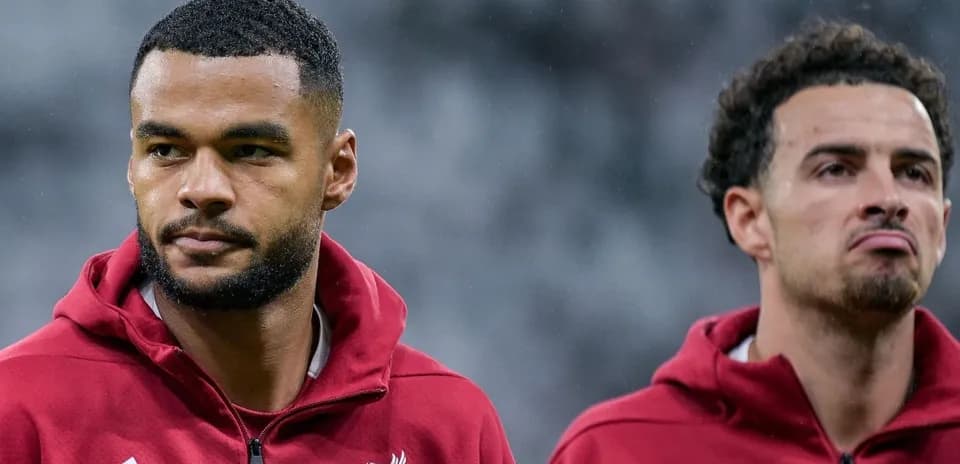 Two Liverpool players in training jackets before match