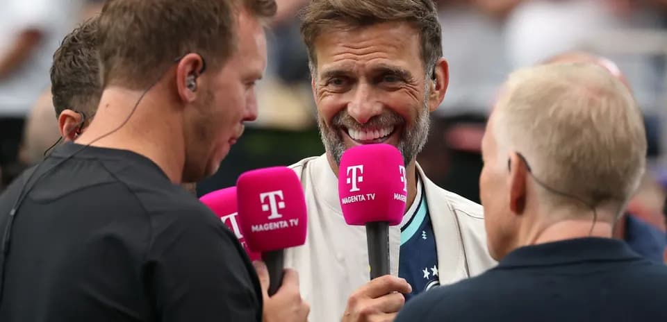 Four people holding microphones during an interview