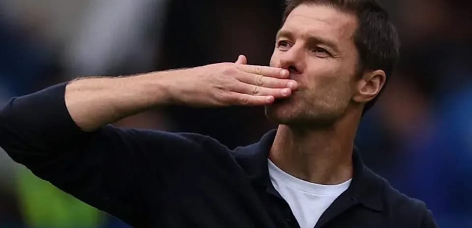 Coach blowing a kiss to the crowd