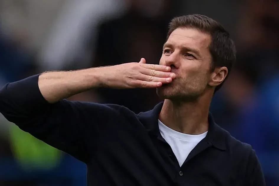 Coach blowing a kiss to the crowd