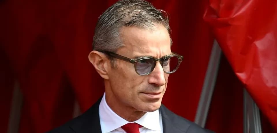 Man in glasses wearing a suit with red tie