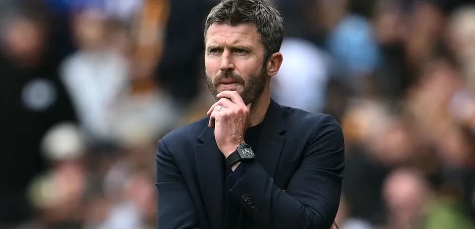 Coach observing the match with thoughtful expression