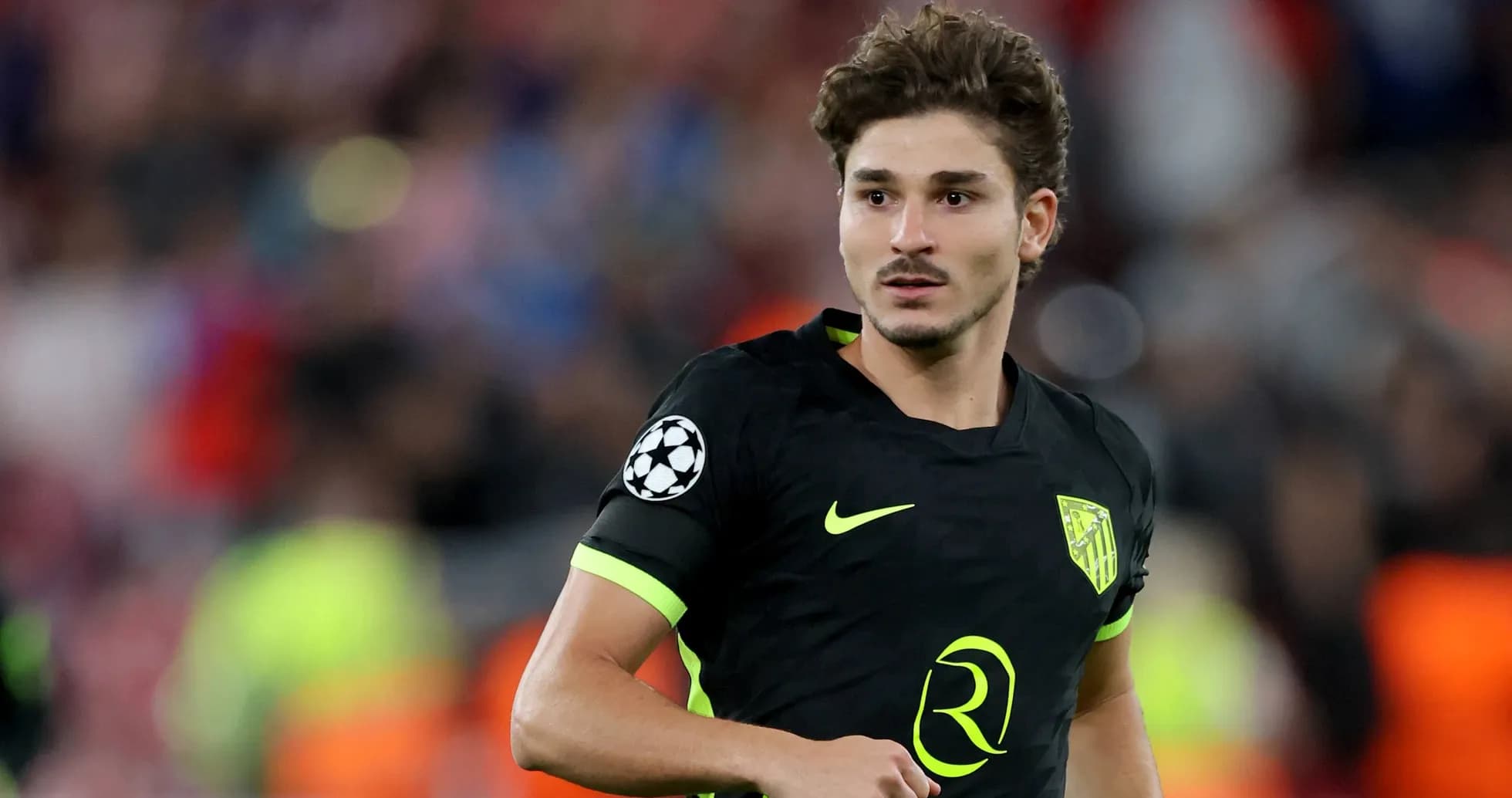 Player in black jersey during Champions League match