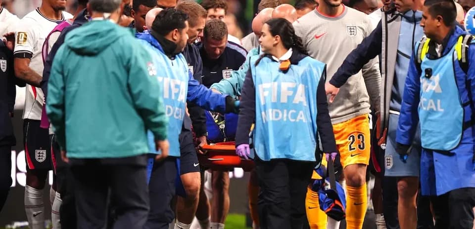 Medical staff assisting player on stretcher during match