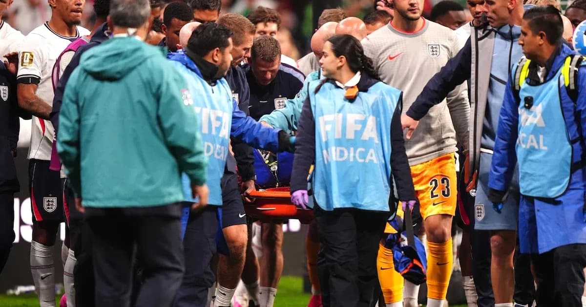 Medical staff assisting player on stretcher during match