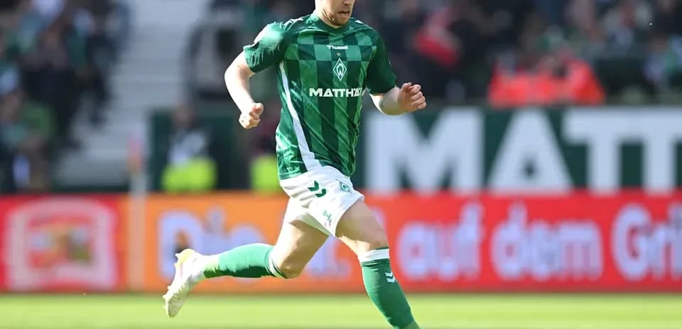 Player running with ball during match on field