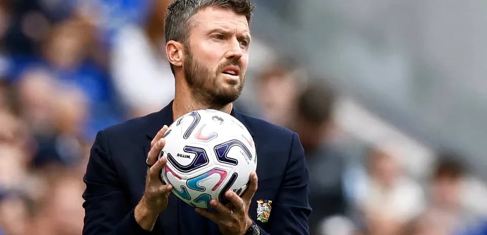 Coach holding ball during match on sidelines