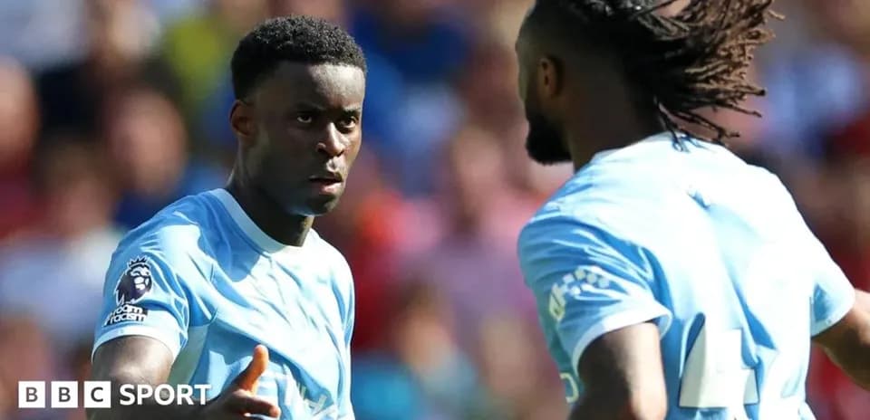 Two players discussing strategy on the field