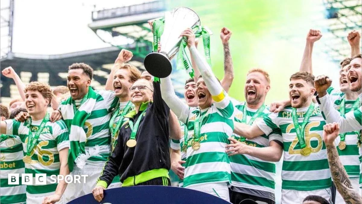 Celtic players celebrating with trophy after victory