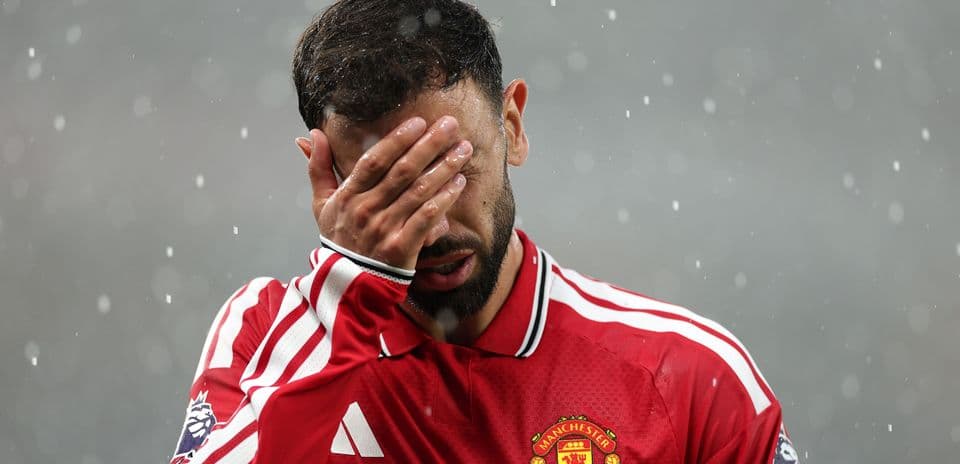Player covering face during rain at match